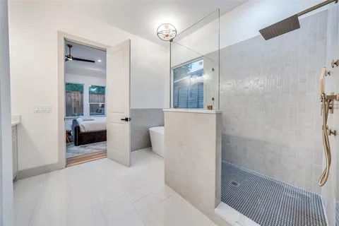 a bedroom with a large bed and a potted plant