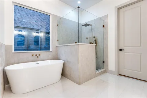 a bathroom with a bathtub and a shower