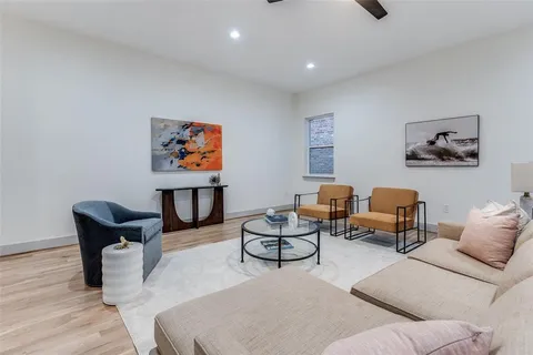 a living room with furniture a rug and a painting on the wall