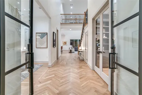 a view of a hallway with a livingroom and furniture