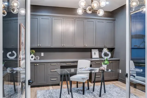 a kitchen with stainless steel appliances granite countertop a microwave a stove and white cabinets