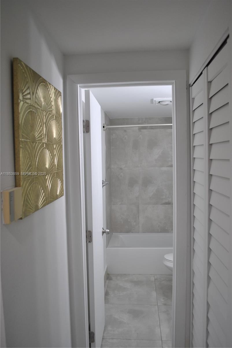 19941 Northeast 5th Court, Unit 3M Miami, FL 33179 - Photo 16 of 25 a bathroom with a glass shower door
