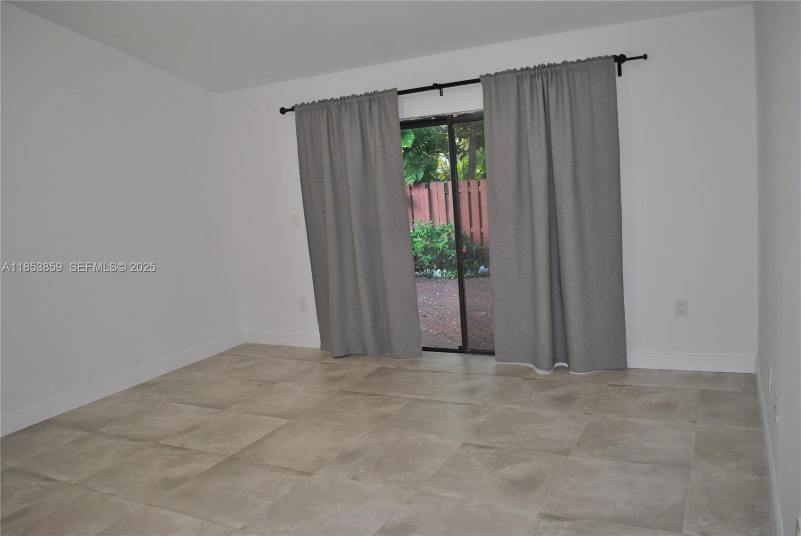 19941 Northeast 5th Court, Unit 3M Miami, FL 33179 - Photo 17 of 25 a view of an empty room with a window