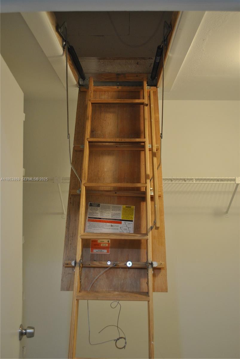 19941 Northeast 5th Court, Unit 3M Miami, FL 33179 - Photo 18 of 25 a view of walk in closet with empty racks
