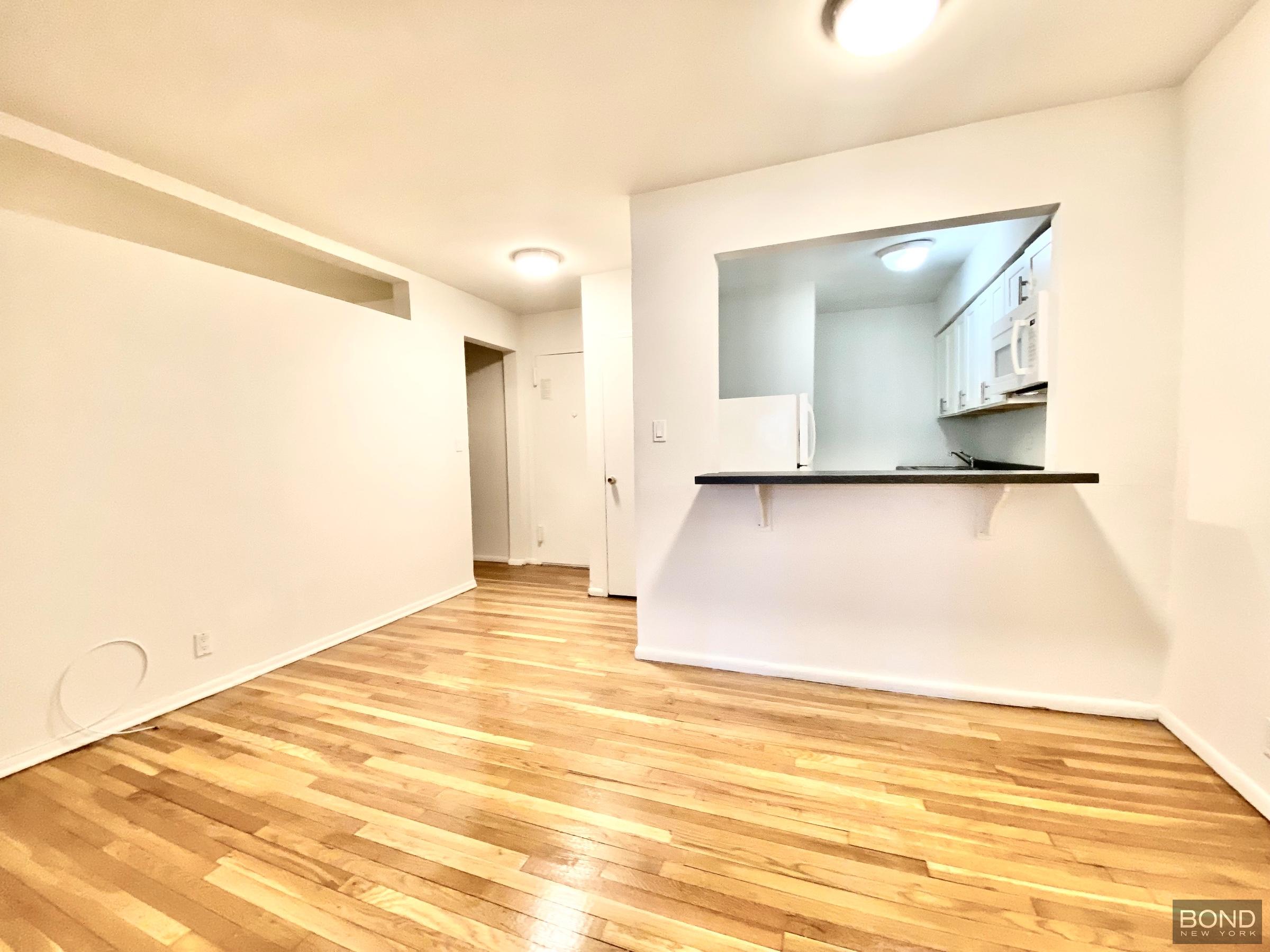 345 East 72nd Street, Unit 2A Manhattan, NY 10021 - Photo 10 of 10 a view of a room with wooden floor and cabinet