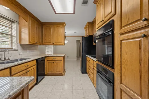 a kitchen with stainless steel appliances lots of counter top space and wooden floor