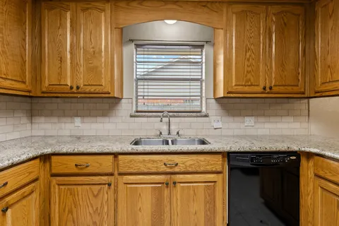 a kitchen with granite countertop cabinets sink and a granite counter top