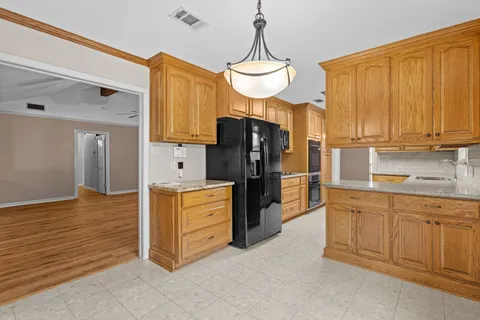 a kitchen with stainless steel appliances a refrigerator and a stove