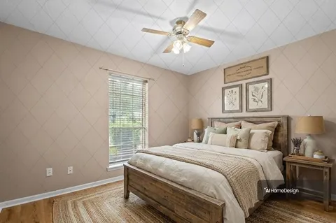 a bedroom with a large bed and a chandelier