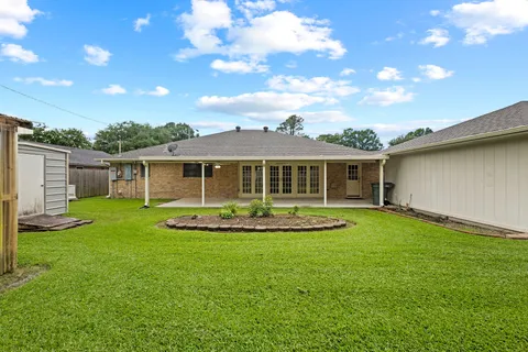 a view of an house with backyard space and balcony
