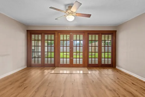 wooden floor in an empty room with a window