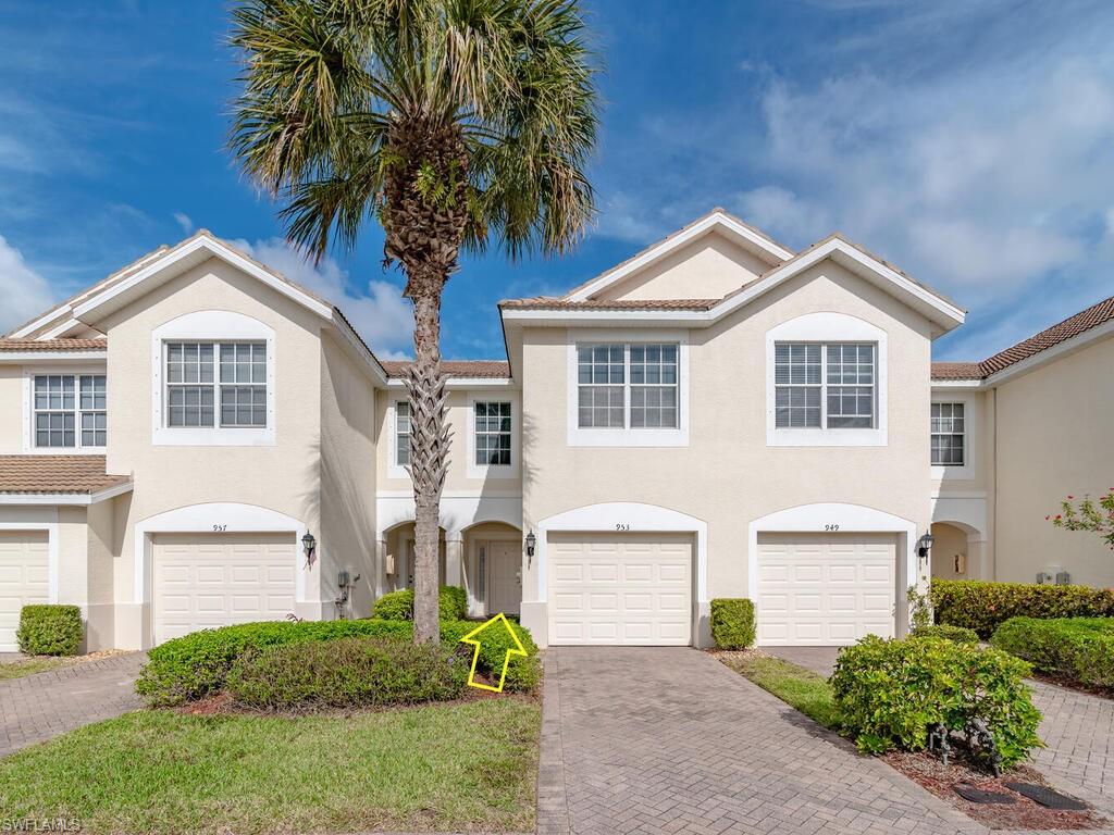a front view of a house with a garden and trees