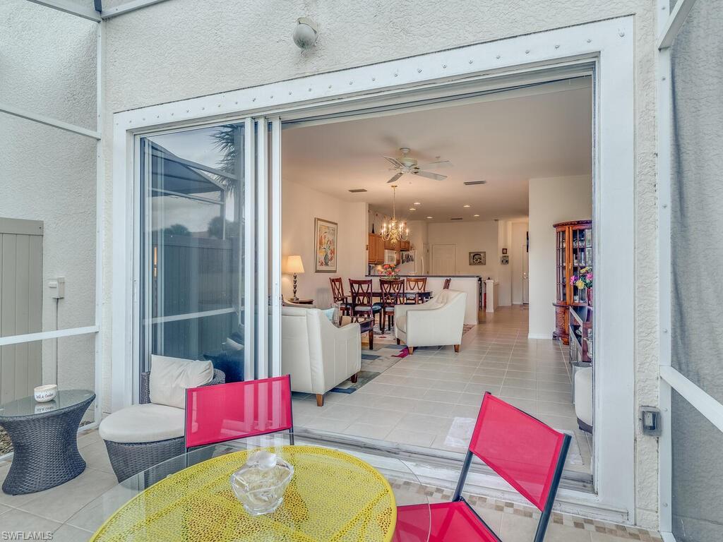 953 Hampton Circle, Unit 112 Naples, FL 34105 - Photo 15 of 35 a living room with furniture and a wooden floor