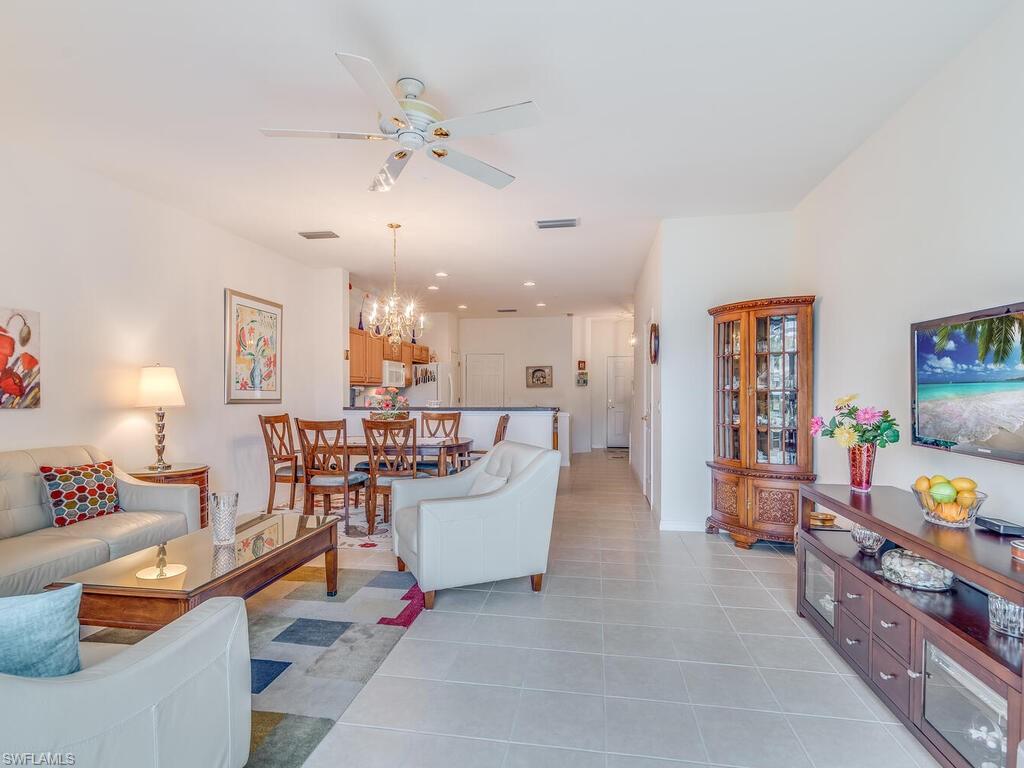 953 Hampton Circle, Unit 112 Naples, FL 34105 - Photo 16 of 35 a living room with furniture and paintings on the wall