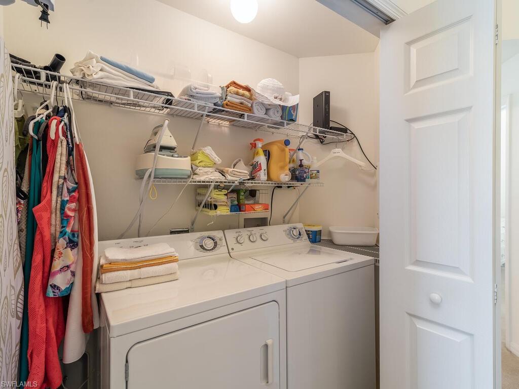 953 Hampton Circle, Unit 112 Naples, FL 34105 - Photo 21 of 35 a utility room with dryer and washer