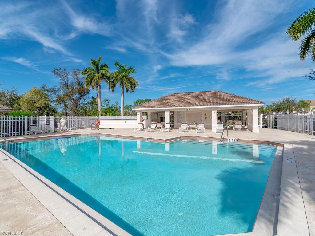953 Hampton Circle, Unit 112 Naples, FL 34105 - Photo 28 of 35 a front view of house with yard and seating