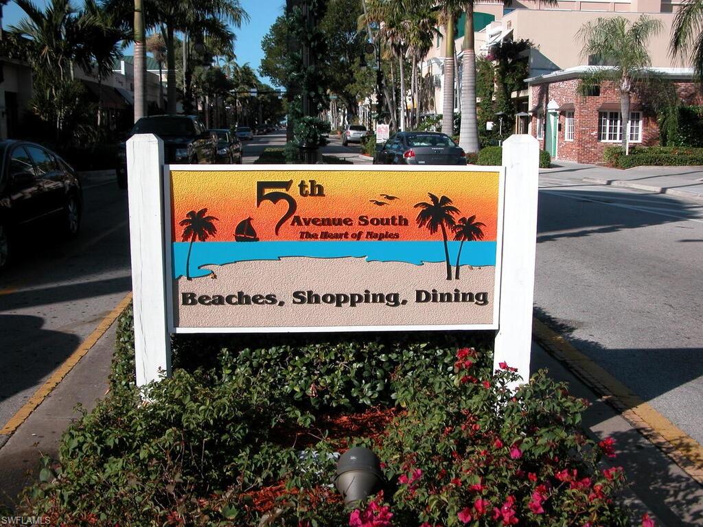 953 Hampton Circle, Unit 112 Naples, FL 34105 - Photo 29 of 35 a sign on the side of the road