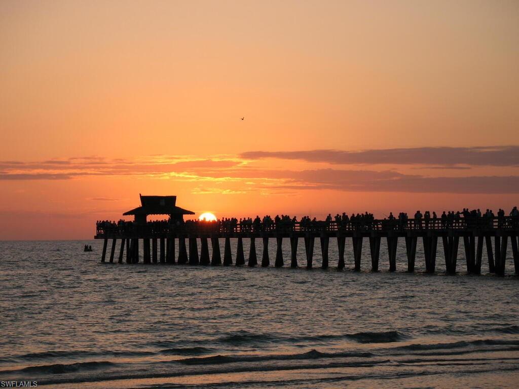 953 Hampton Circle, Unit 112 Naples, FL 34105 - Photo 30 of 35 a view of a roof deck with wooden floor and fence