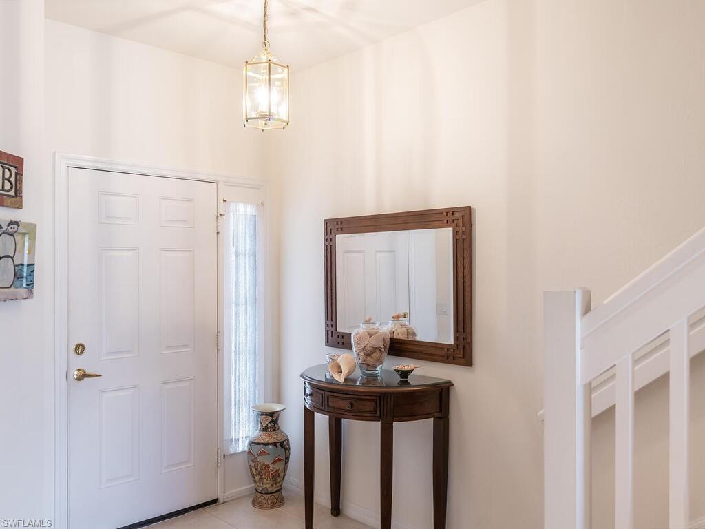 953 Hampton Circle, Unit 112 Naples, FL 34105 - Photo 3 of 35 a bathroom with a sink a mirror and a toilet