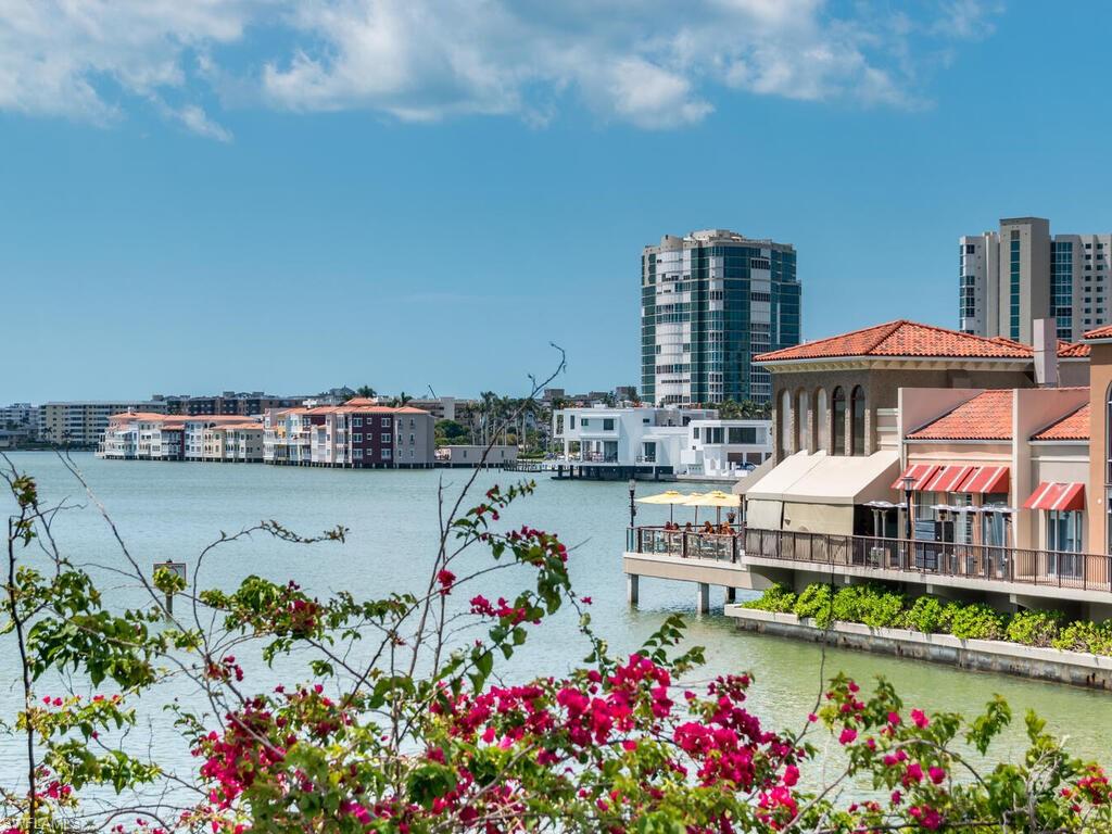953 Hampton Circle, Unit 112 Naples, FL 34105 - Photo 34 of 35 a view of swimming pool with outdoor seating and yard in back