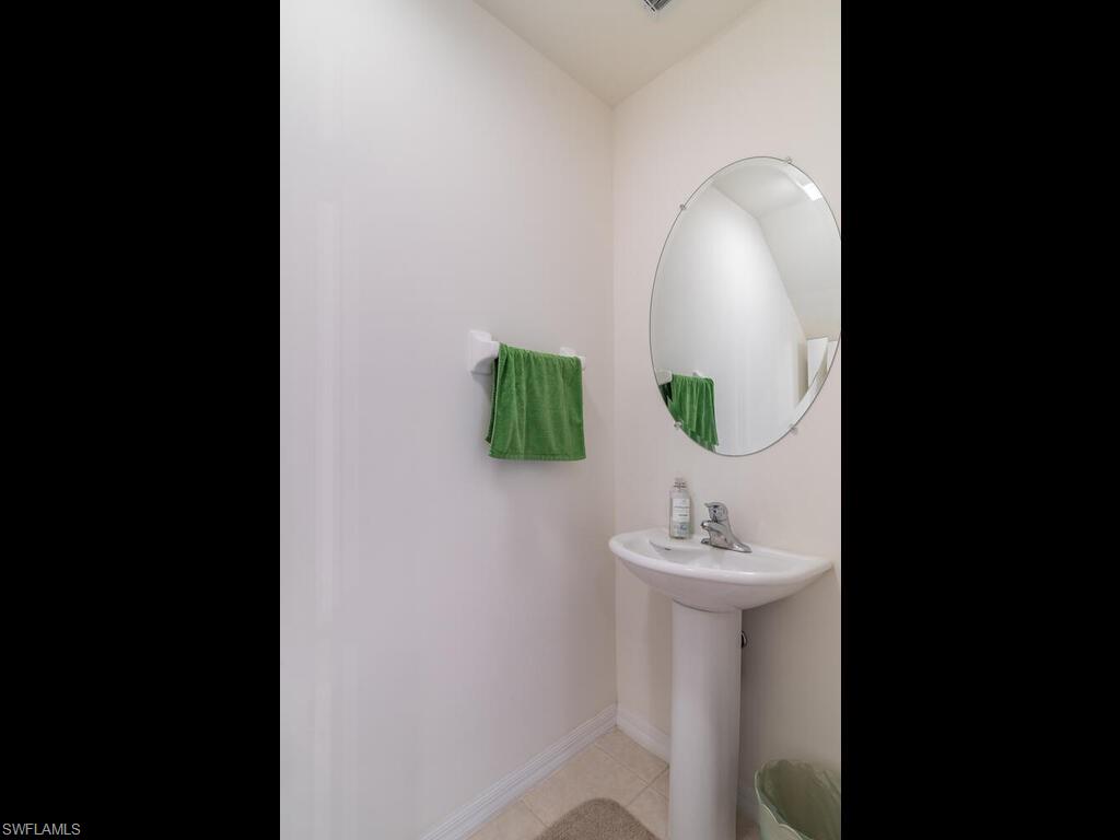 953 Hampton Circle, Unit 112 Naples, FL 34105 - Photo 8 of 35 a bathroom with a sink and a mirror