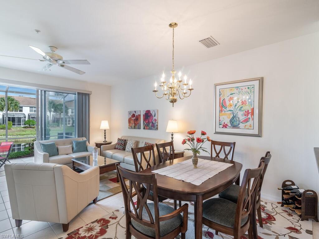 953 Hampton Circle, Unit 112 Naples, FL 34105 - Photo 9 of 35 a view of a dining room with furniture a chandelier and a window