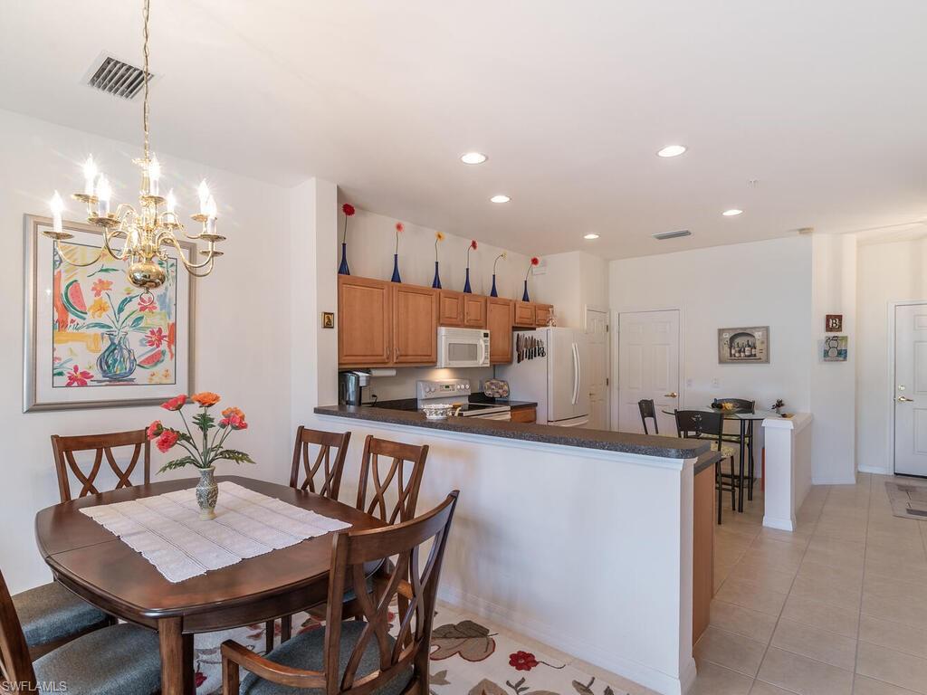 953 Hampton Circle, Unit 112 Naples, FL 34105 - Photo 10 of 35 a view of a dining room with furniture