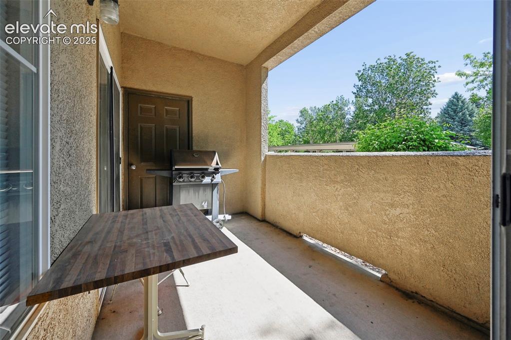 3715 Riviera Grove, Unit 101 Colorado Springs, CO 80922 - Photo 31 of 36 Private exterior balcony featuring a stucco finish, concrete flooring, and a sliding glass door