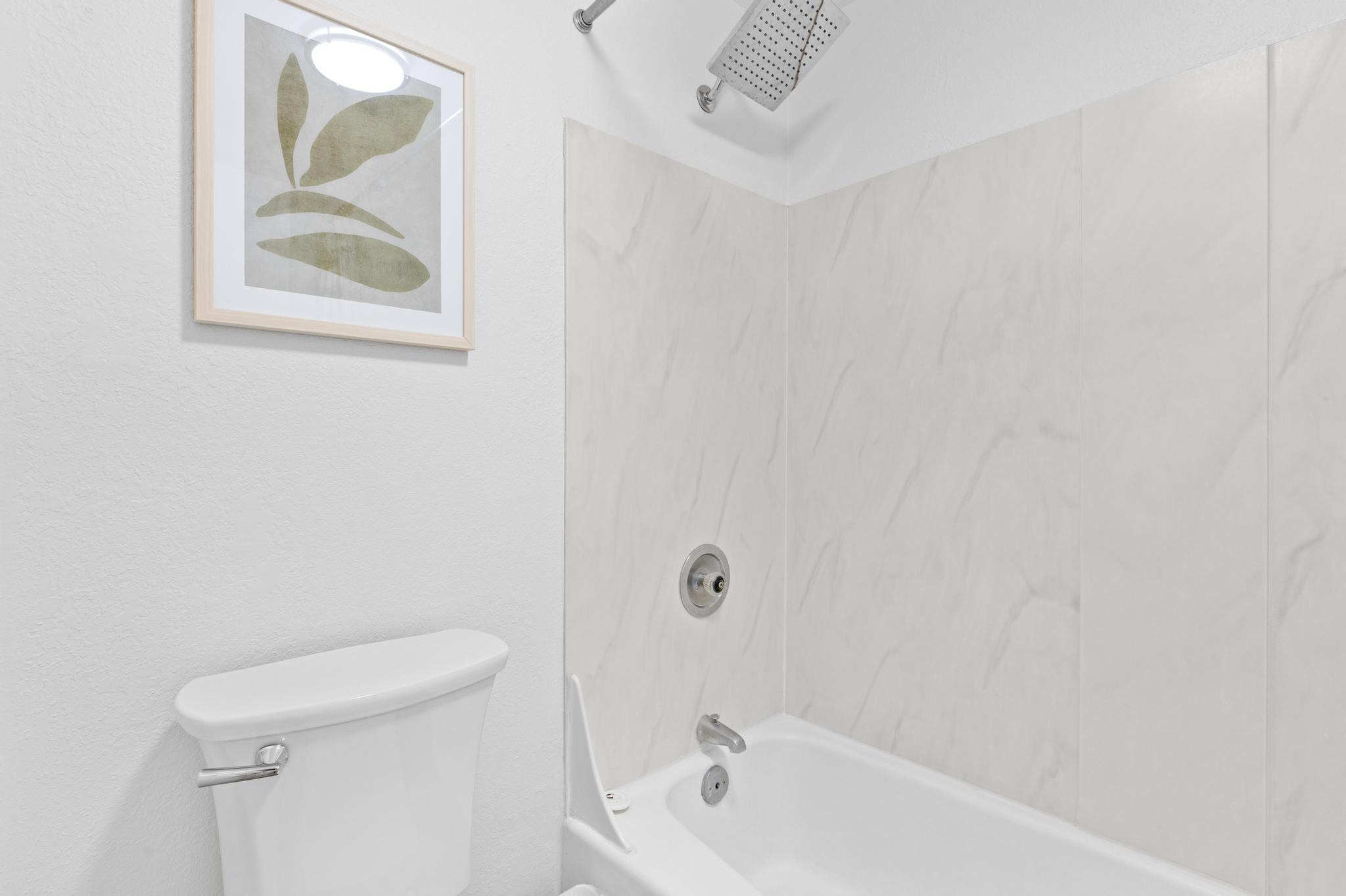 68-3840 Lua Kula Street, Unit F203 Waikoloa, HI 96738 - Photo 13 of 29 a bathroom with a bathtub and a toilet