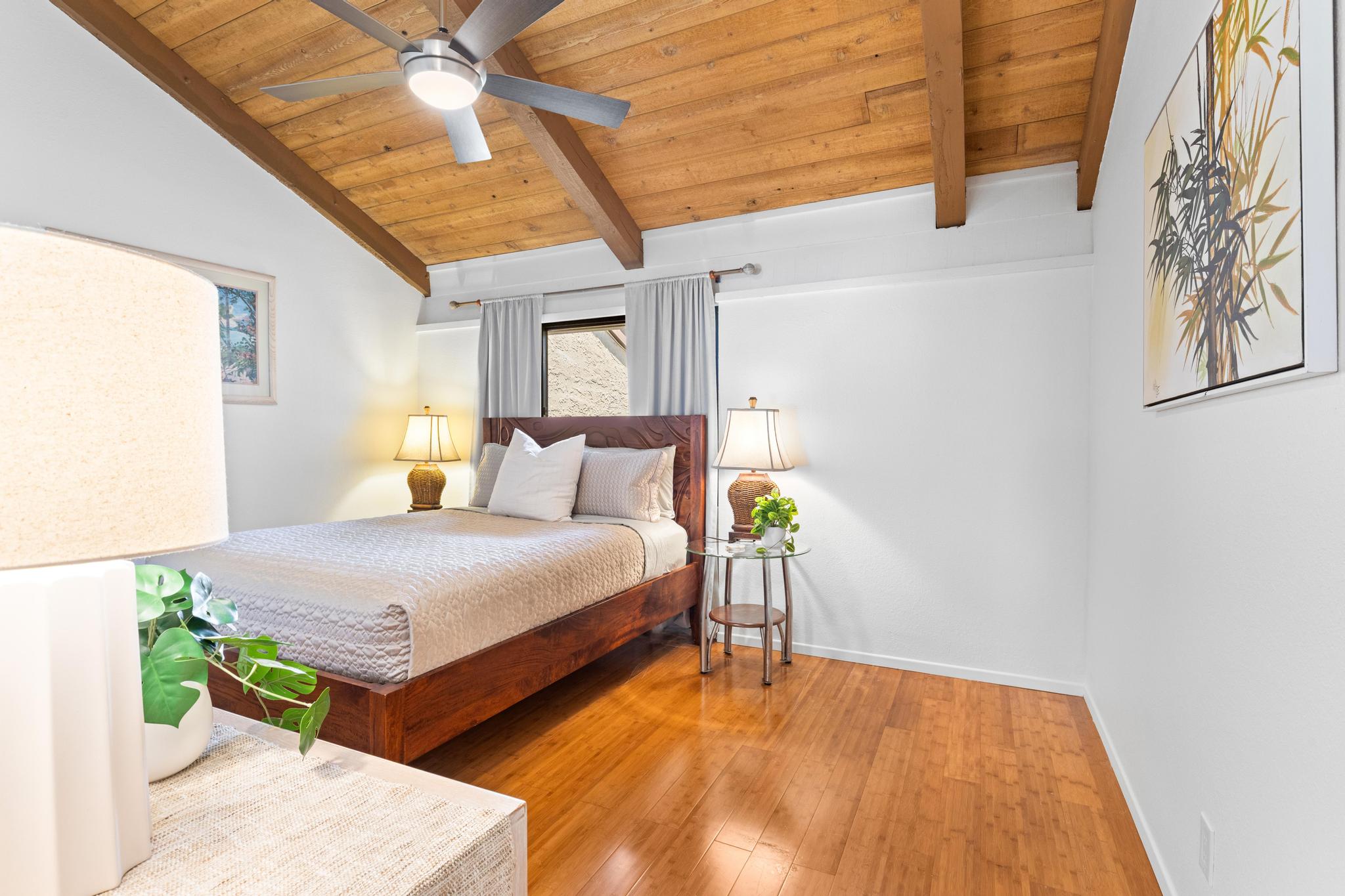 68-3840 Lua Kula Street, Unit F203 Waikoloa, HI 96738 - Photo 16 of 29 a bedroom with a bed and wooden floor