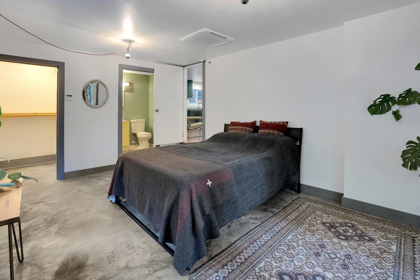 845 Redwood Road Felton, CA 95018 - Photo 16 of 28 a spacious bedroom with a bed and a table in it