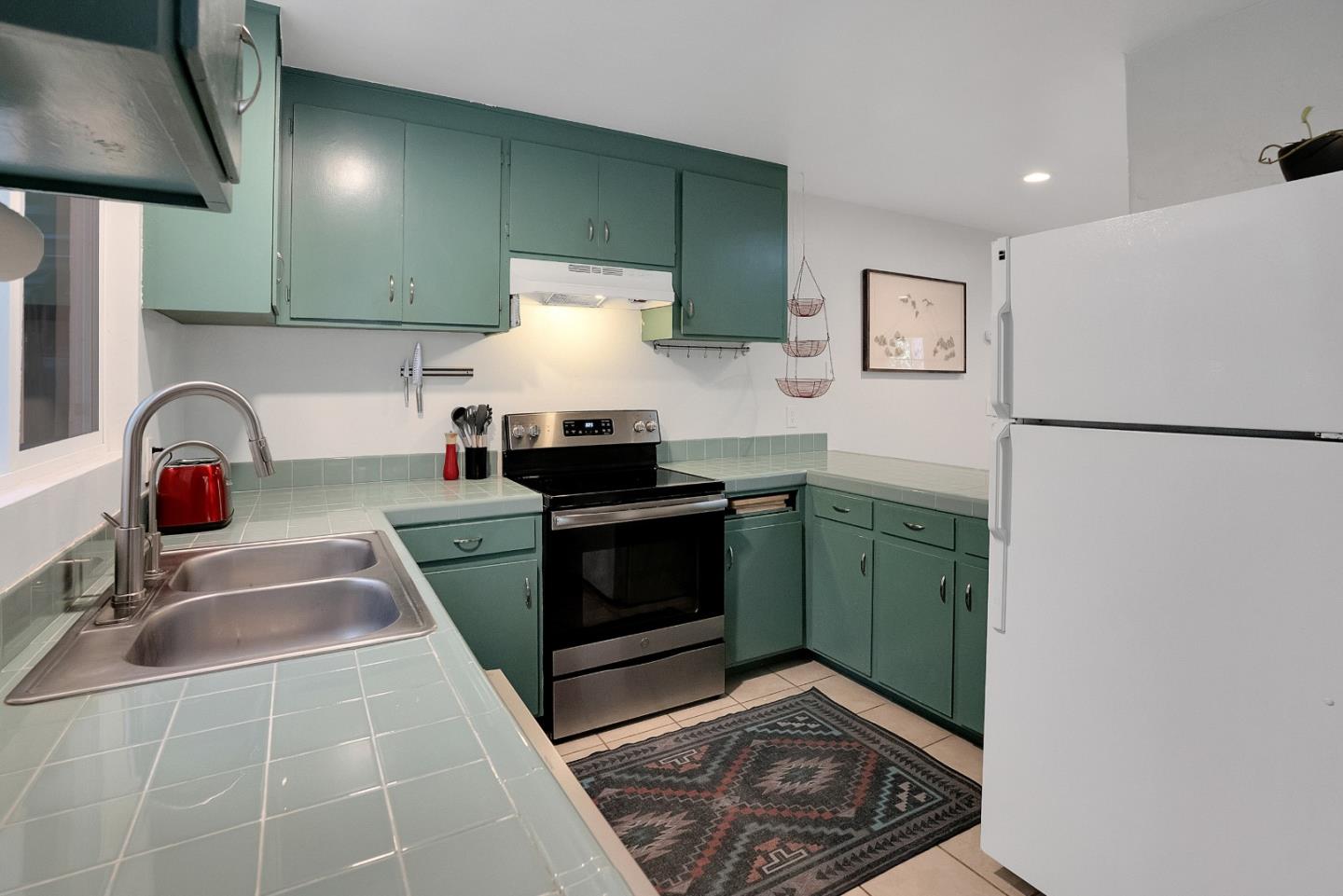 845 Redwood Road Felton, CA 95018 - Photo 8 of 28 a kitchen with a sink a stove and a refrigerator