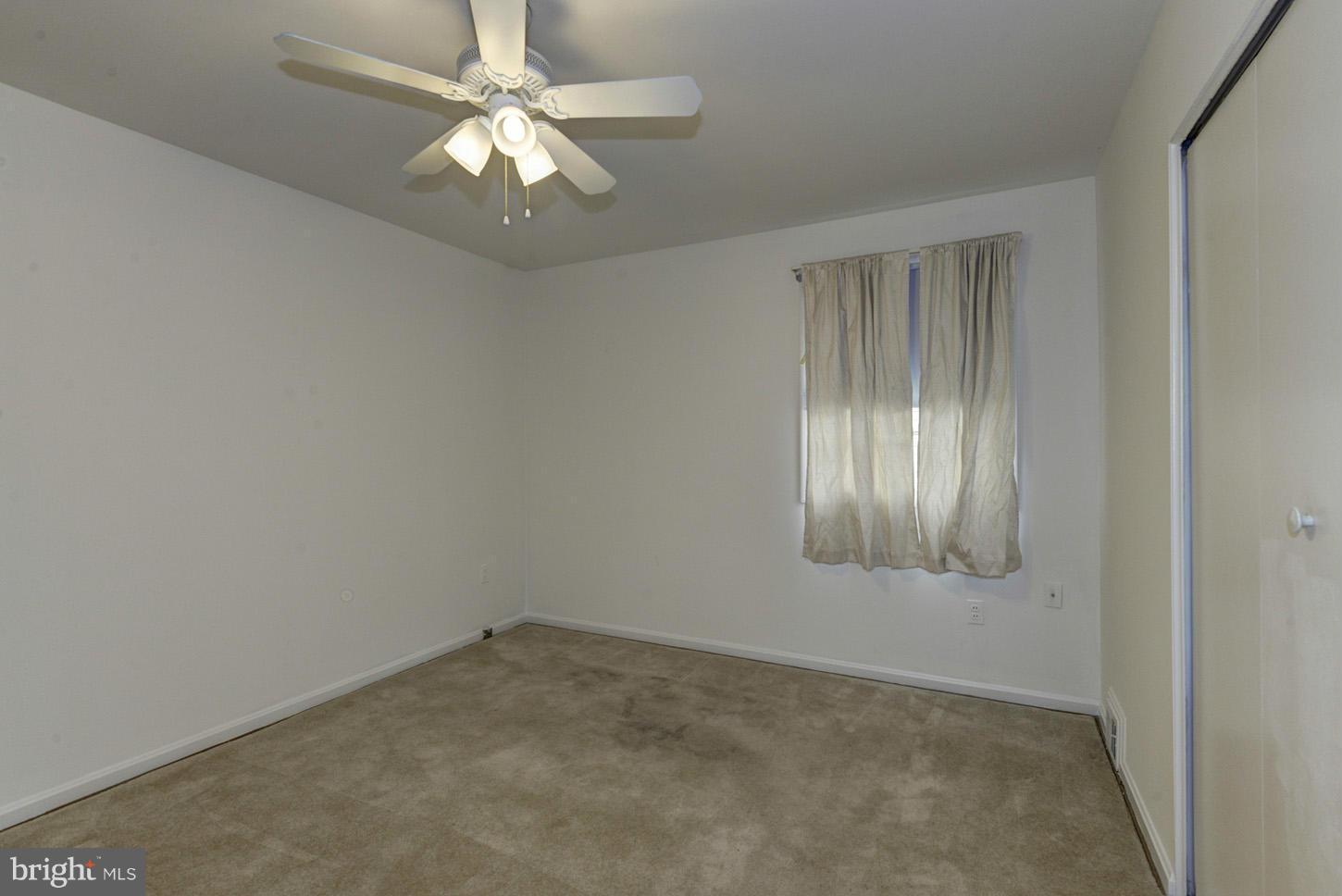 12515 Barbara Road Silver Spring, MD 20906 - Photo 4 of 8 an empty room with windows and fan