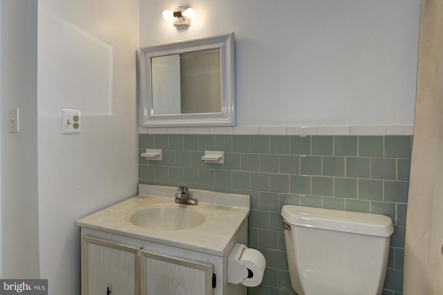 12515 Barbara Road Silver Spring, MD 20906 - Photo 5 of 8 a bathroom with a sink a toilet and a mirror