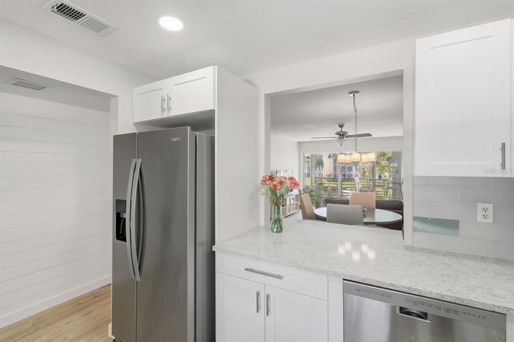 4380 Exeter Drive, Unit H202 Longboat Key, FL 34228 - Photo 14 of 37 a kitchen with a refrigerator and a sink