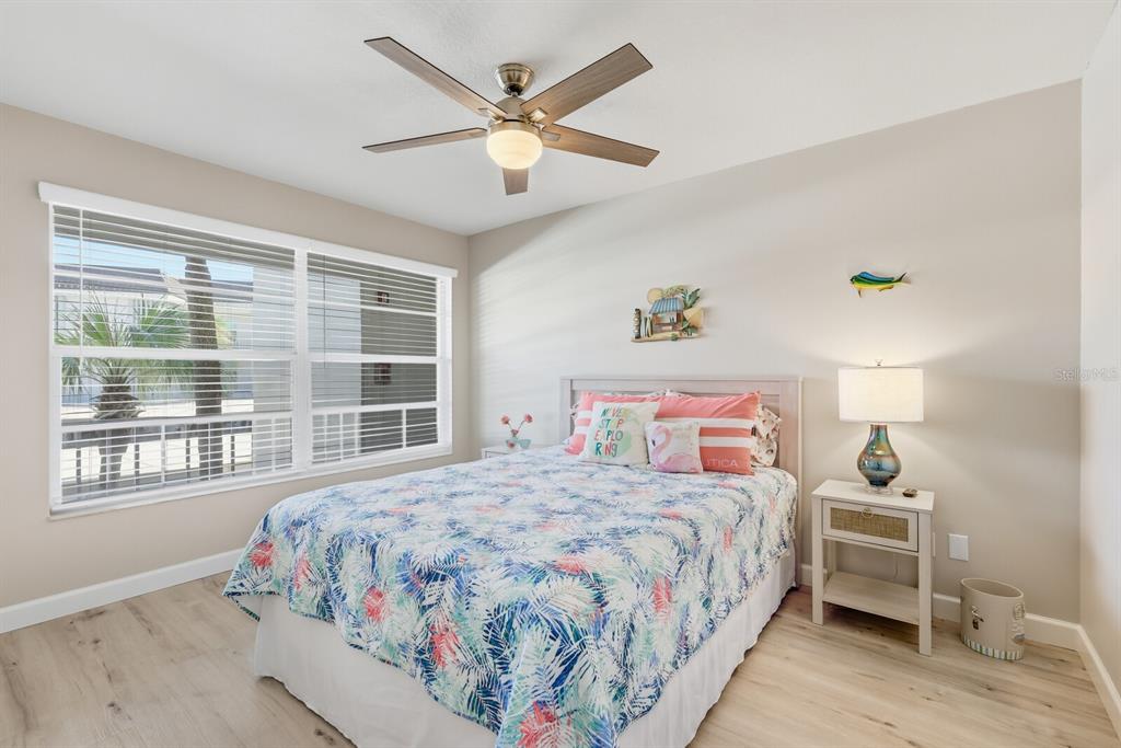 4380 Exeter Drive, Unit H202 Longboat Key, FL 34228 - Photo 22 of 37 a bedroom with a large bed and a window