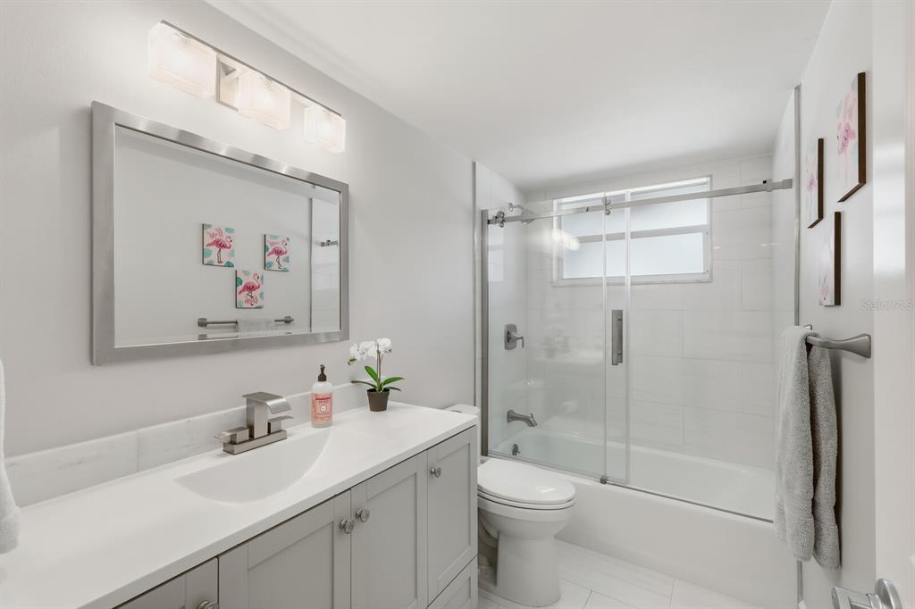 4380 Exeter Drive, Unit H202 Longboat Key, FL 34228 - Photo 24 of 37 a bathroom with a sink a toilet and shower
