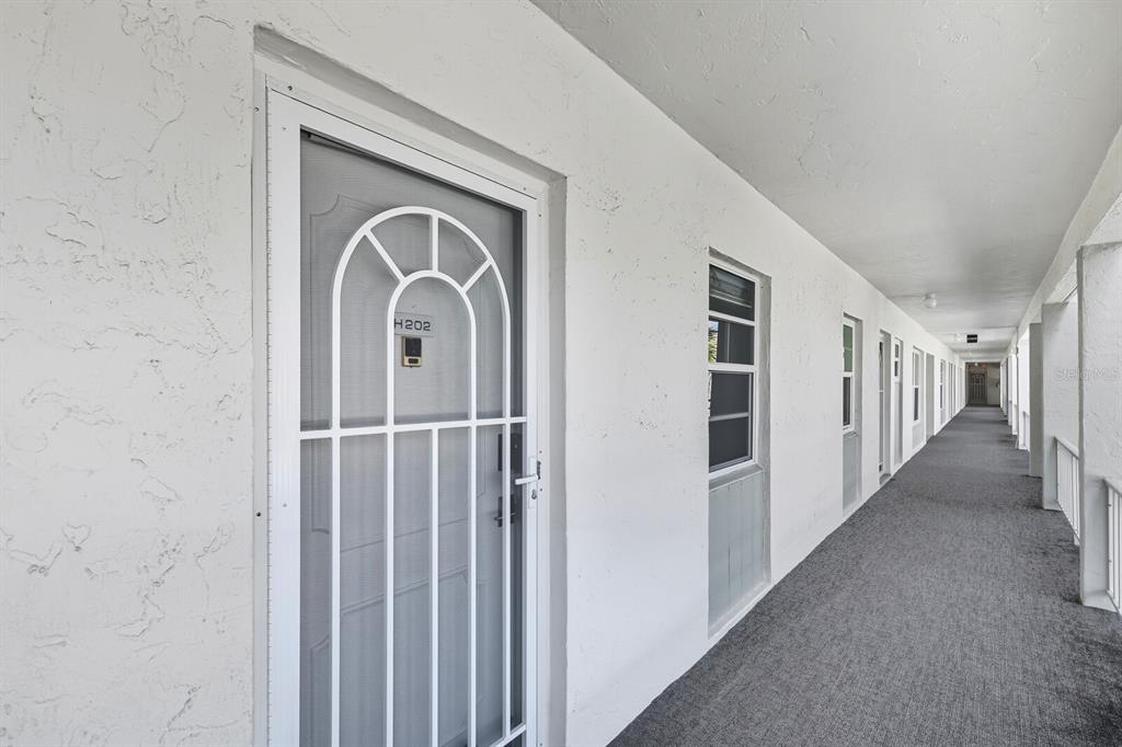 4380 Exeter Drive, Unit H202 Longboat Key, FL 34228 - Photo 26 of 37 a view of a hallway with windows