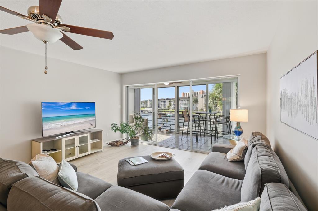 4380 Exeter Drive, Unit H202 Longboat Key, FL 34228 - Photo 6 of 37 a living room with furniture a ceiling fan and a window