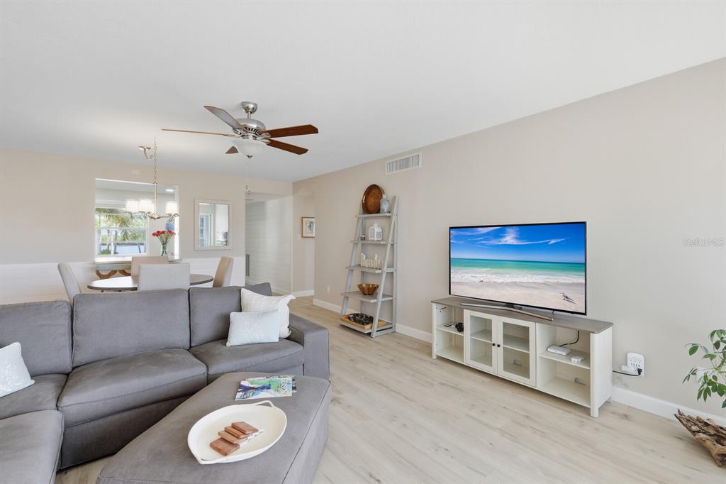 4380 Exeter Drive, Unit H202 Longboat Key, FL 34228 - Photo 9 of 37 a living room with furniture and wooden floor