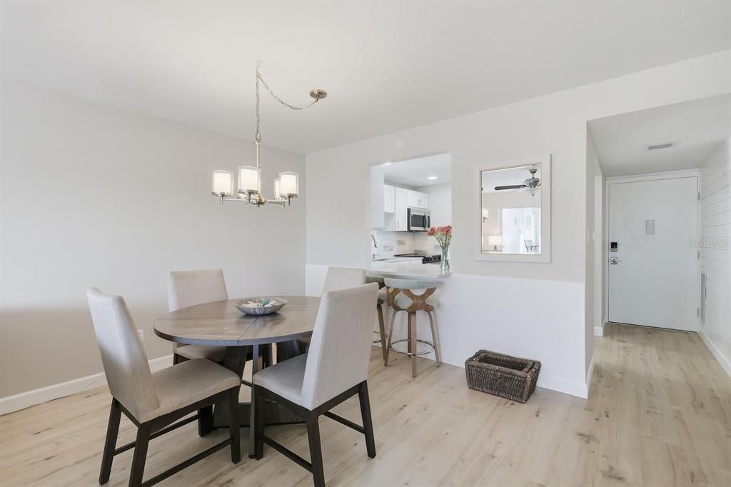 4380 Exeter Drive, Unit H202 Longboat Key, FL 34228 - Photo 10 of 37 a view of a dining room with furniture