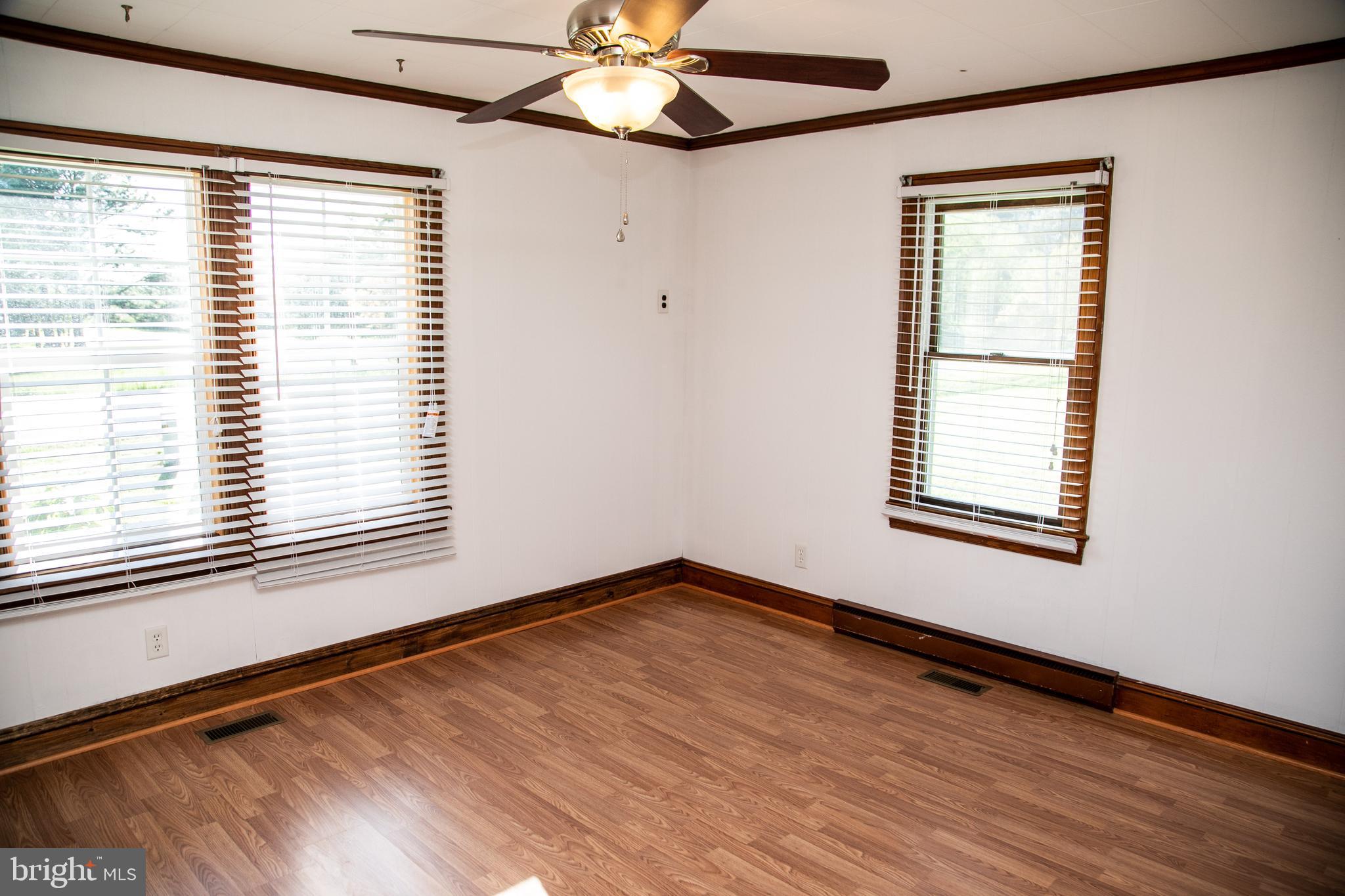 20135 Nanticoke Road Nanticoke, MD 21840 - Photo 28 of 47 a view of an empty room with wooden floor and a window