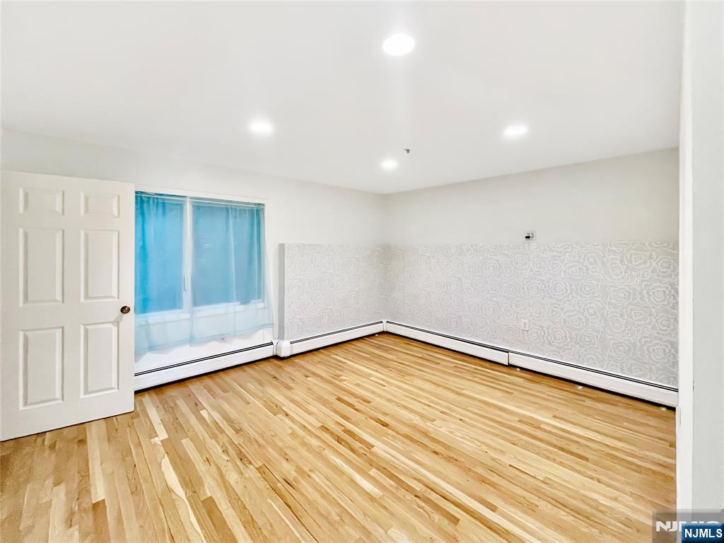 8913 Riverside Place, Unit 3 North Bergen, NJ 07047 - Photo 8 of 17 a view of empty room with wooden floor