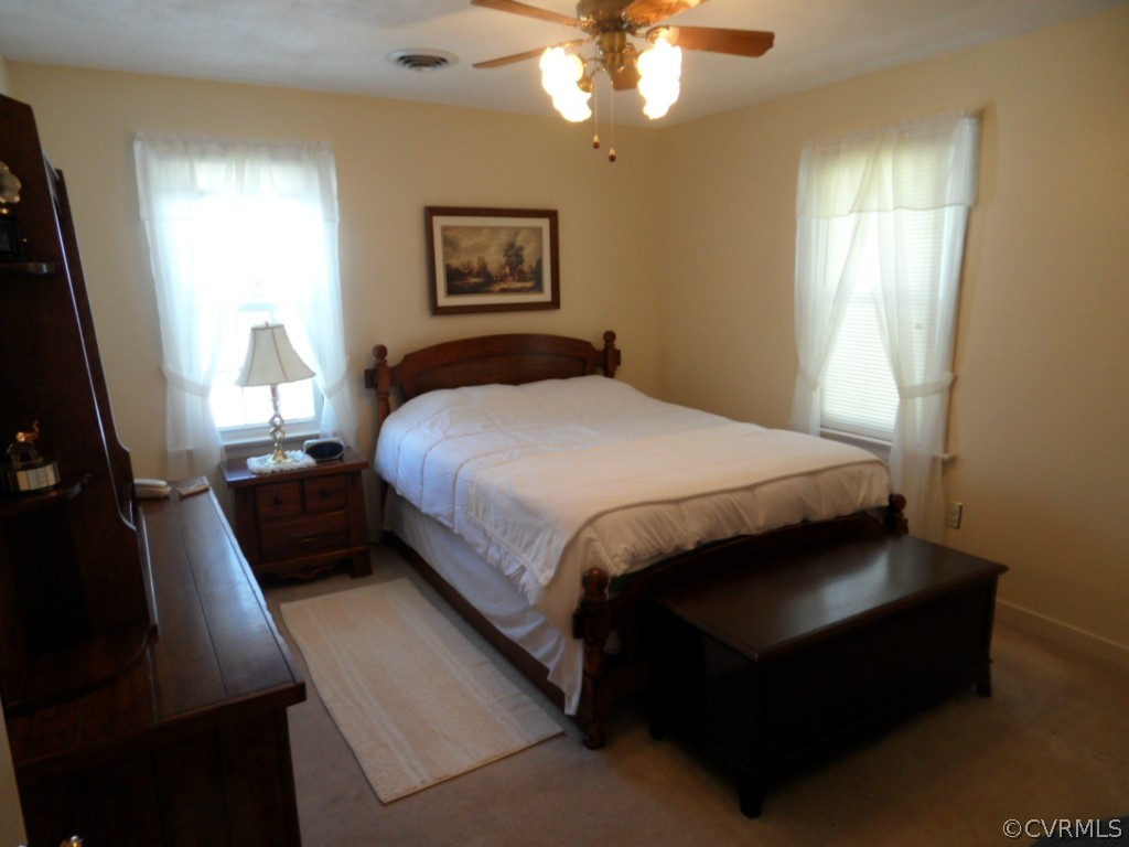 7118 Barkbridge Road Chesterfield, VA 23832 - Photo 15 of 24 a bedroom with a bed and a chandelier