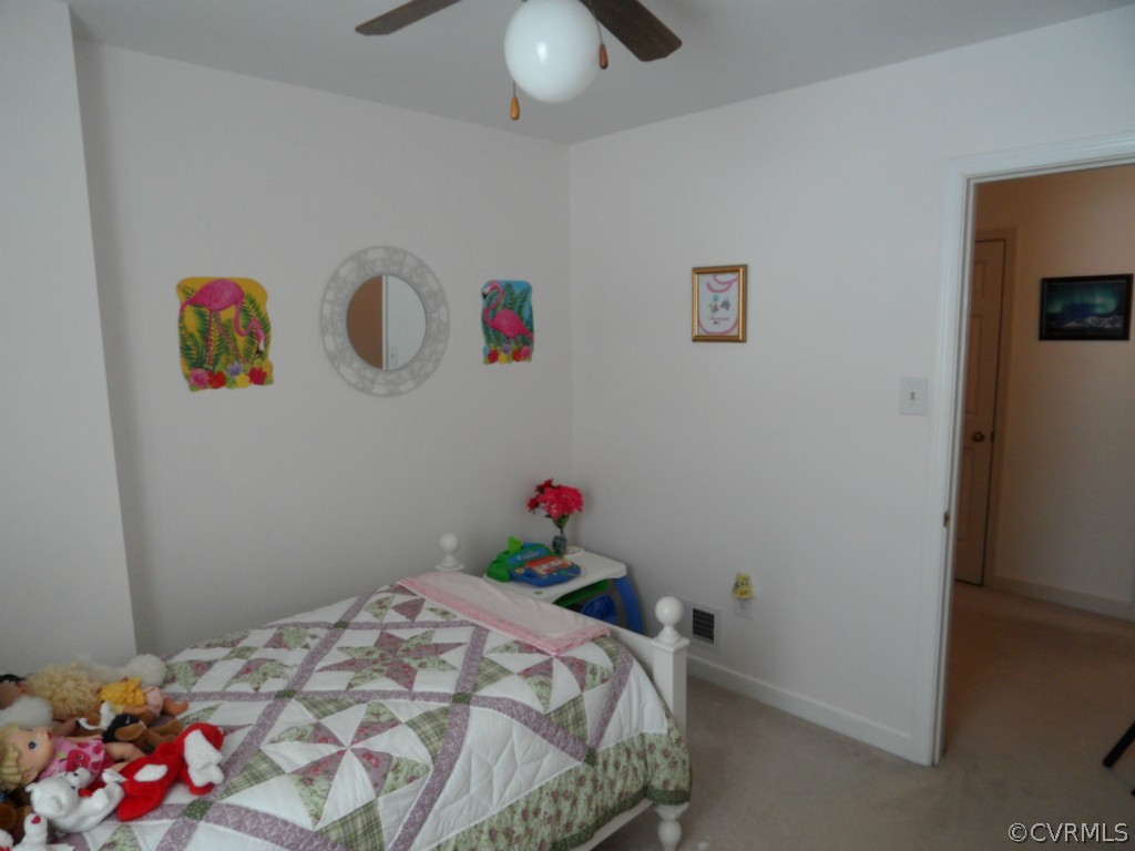 7118 Barkbridge Road Chesterfield, VA 23832 - Photo 17 of 24 a bedroom with a bed and a chandelier