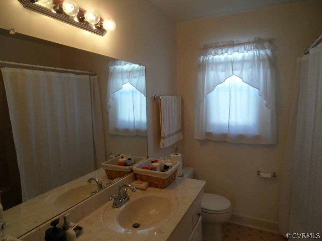7118 Barkbridge Road Chesterfield, VA 23832 - Photo 18 of 24 a bathroom with a sink toilet and mirror