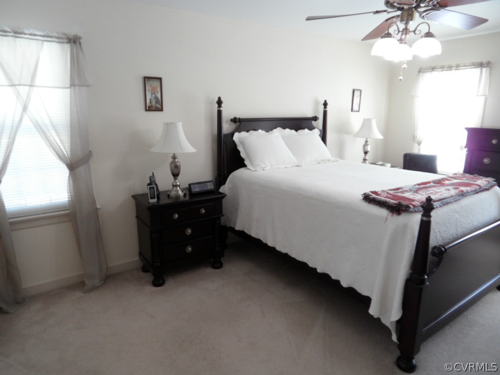 7118 Barkbridge Road Chesterfield, VA 23832 - Photo 21 of 24 a bedroom with a bed and a chandelier
