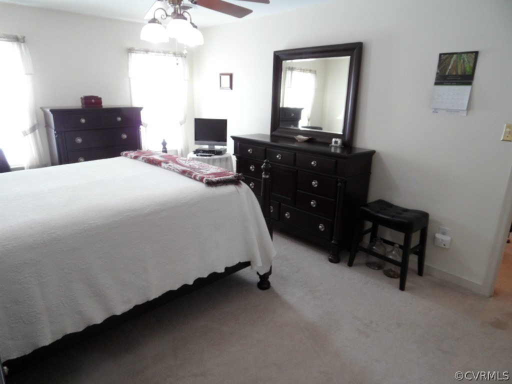 7118 Barkbridge Road Chesterfield, VA 23832 - Photo 23 of 24 a spacious bedroom with a bed and a chandelier