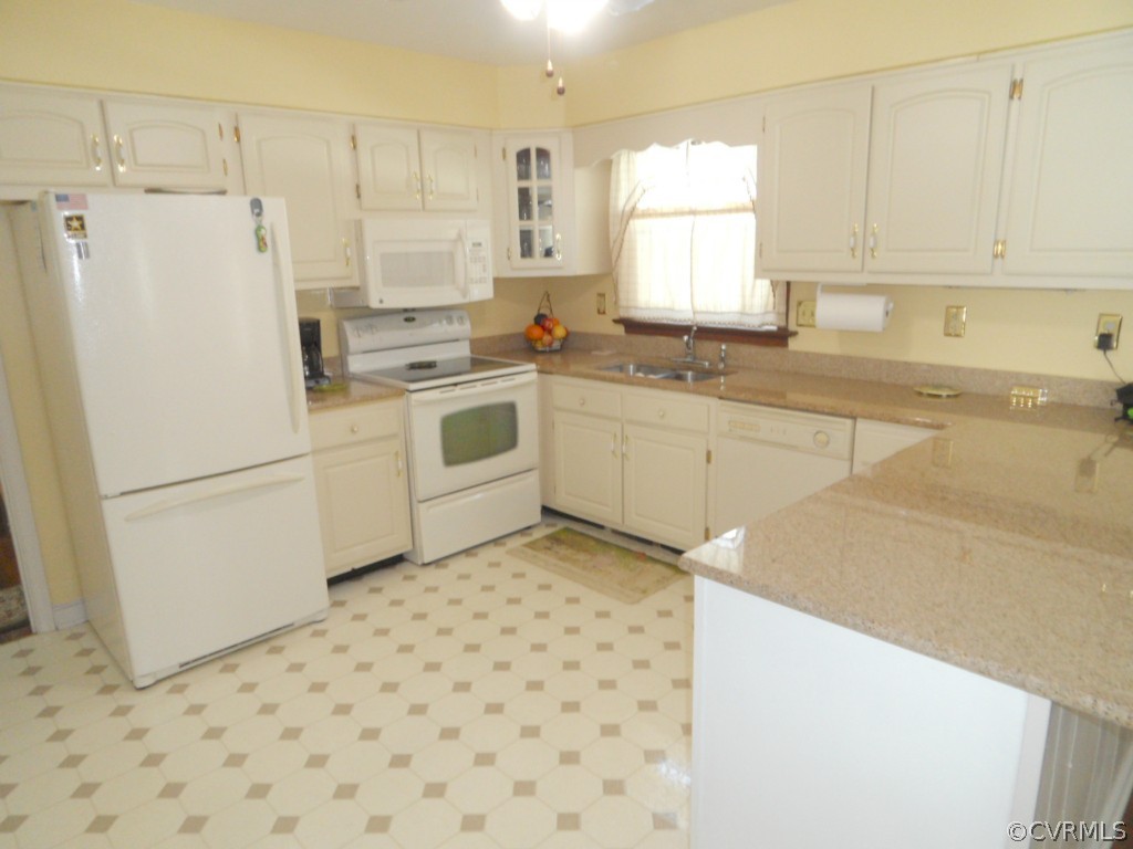 7118 Barkbridge Road Chesterfield, VA 23832 - Photo 9 of 24 a kitchen with a white cabinets and white appliances