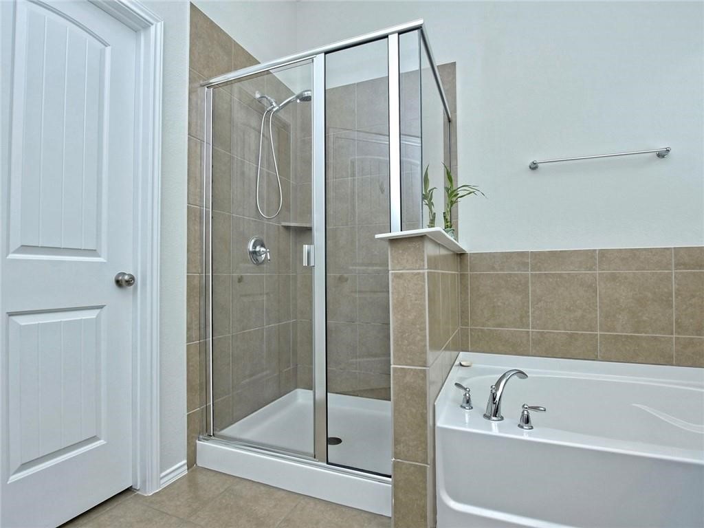 305 Methodius Drive Hutto, TX 78634 - Photo 16 of 26 a bathroom with a bathtub and shower